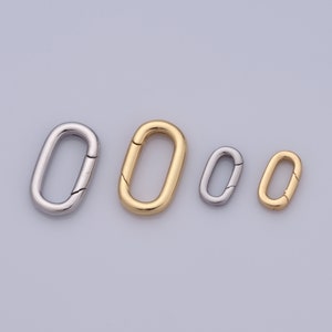 May include: Four oval-shaped metal clasps in different sizes. The clasps are silver and gold in color.