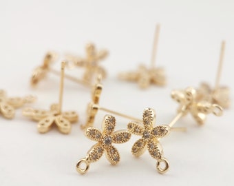 May include: Two gold-tone flower-shaped earring findings with clear rhinestones. Each finding has a loop at the bottom for attaching a dangle charm.