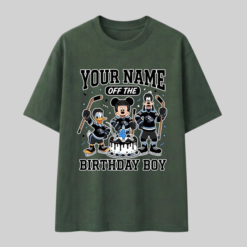May include: Dark green t-shirt with a cartoon graphic of Mickey Mouse, Donald Duck, and Goofy in hockey attire. The shirt displays the text "YOUR NAME OFF THE BIRTHDAY BOY". A birthday cake with the number 4 is in the center of the design.