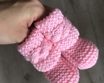 Handknitted baby socks/booties with braid.