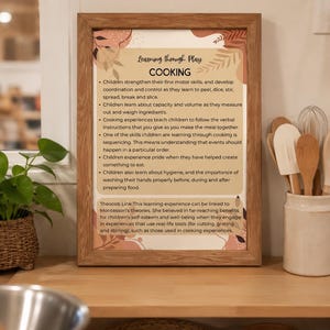 May include: A framed educational poster titled Learning through Play COOKING, featuring text about children developing motor skills, coordination, and sequencing through cooking, with abstract botanical illustrations in shades of brown and beige.