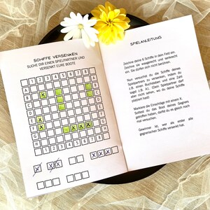 May include: A printable game board for the game Battleship. The board is divided into a grid of 8x8 squares. The squares are labeled with letters A through H and numbers 1 through 8. The game board is printed on white paper with black lines. The game board is designed for two players.