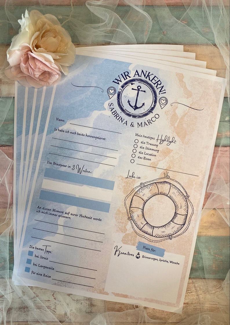 May include: A stack of wedding stationery with a nautical theme. The design features an anchor, the names "Sabrina & Marco", and fill-in-the-blank prompts. The color scheme includes blue, beige, and white, with a decorative floral accent.