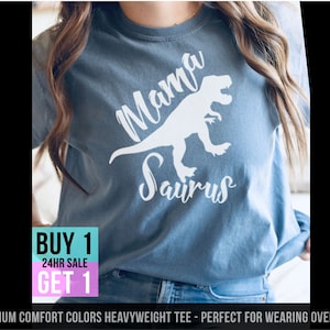 May include: A blue t-shirt with a white dinosaur graphic and the text "Mama Saurus".