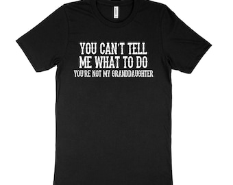 May include: Black t-shirt with white text that reads "You can't tell me what to do You're not my granddaughter".