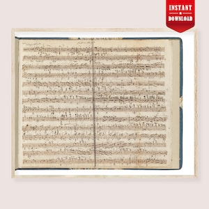 May include: A framed print of antique sheet music. The pages are covered in handwritten musical notation in brown ink. The paper has a vintage, aged look. The frame is light wood, and the background is white.