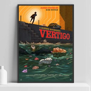 May include: A framed movie poster for Alfred Hitchcock's "Vertigo." The artwork features a man running, a woman in water, and the title in red. The poster has a vintage style with a color palette of orange, black, and green.