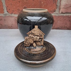 May include: A set of three ceramic mugs with a speckled, matte finish. The mugs are in shades of cream, light grey, and dark grey. Each mug has a simple, minimalist design, ideal for coffee or tea.