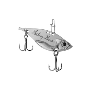 May include: Silver fishing lure with a personalized inscription that reads "Anthony Kwan".