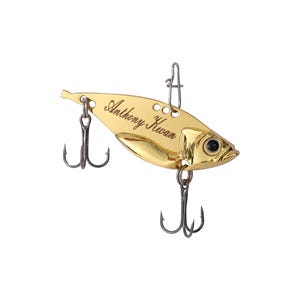 May include: Gold-colored fishing lure with a personalized inscription that reads "Anthony Kwan".