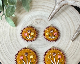 Round leather beaded earrings with Quill accents in orange and red tones