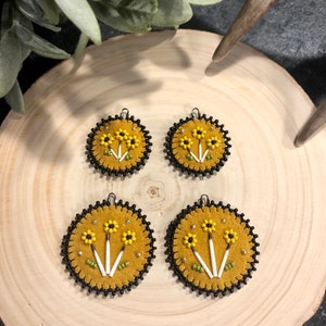 Round leather earrings with quill accents in yellow, black and gold