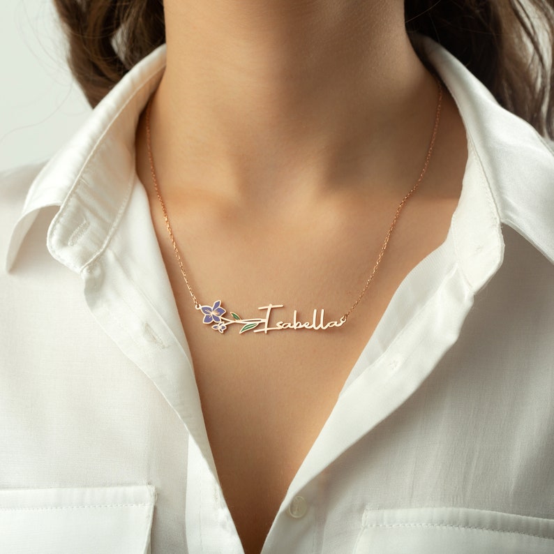 This is a personalization colored Violet February birth flower. Its leaves are green, its flower is purple. The necklace stands horizontally on the model's neck.
You can choose the material and other birth month flower you want.