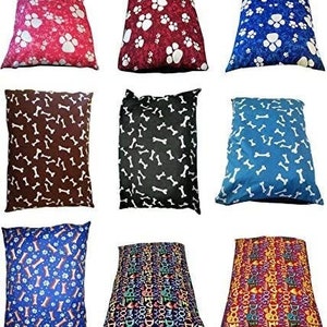 May include: Nine different dog bed designs. The designs include paw prints, bones, and the word "dog" repeated in various colors and fonts.