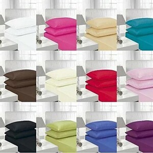 May include: A selection of bed linen sets in a variety of colours: white, pink, yellow, teal, brown, cream, red, light pink, black, green, blue, and purple. Each set includes a fitted sheet and pillowcases, displayed on a bed.