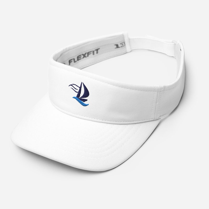 Pode incluir: Visor branco com um logotipo de veleiro azul e preto bordado na frente. O visor tem um logotipo "Flexfit" preto na parte de tr&aacute;s.