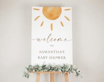 May include: Welcome to Samantha's Baby Shower sign with a watercolor sun illustration in gold on a white background.