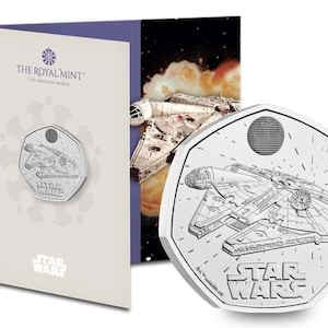 May include: A silver coin featuring a line drawing of the Millennium Falcon from Star Wars. The coin is a 50 pence piece and has the words "Star Wars" on it.