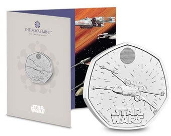 May include: A silver coin featuring a Star Wars X-Wing fighter in flight. The coin is a 50 pence piece from the Royal Mint and has the words "Star Wars" inscribed on it.