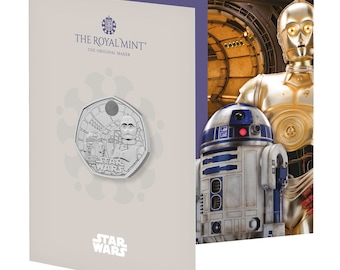 May include: A silver coin featuring R2-D2 and C-3PO from Star Wars. The coin is in a display case with a background image of the characters in a Star Wars setting. The Royal Mint logo and the words "The Original Maker" are printed on the case.