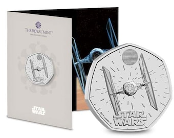 May include: A silver coin featuring a detailed illustration of a TIE fighter from Star Wars. The coin is a 50 pence piece and has the words "Star Wars" inscribed on it.