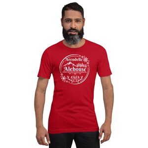 May include: Red short-sleeved t-shirt with a white graphic of a mountain scene and the text "Arendelle Alehouse, Where the cold never bothers you".