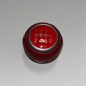 May include: A set of three ceramic mugs with a speckled, matte finish. The mugs are in shades of cream, light gray, and dark gray. Each mug has a simple, minimalist design, perfect for coffee or tea.