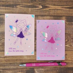 May include: Two pink cards with a tooth fairy illustration and the text "With Love from the Tooth Fairy".