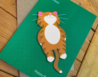 May include: A green card with a cartoon orange tabby cat with pink cheeks and a white belly. The cat is smiling and has its eyes closed. The text on the card reads "And relax." and "Happy Retirement."