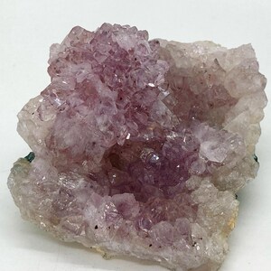 May include: A large cluster of amethyst crystals with a deep purple hue. The crystals are arranged in a natural formation, creating a unique and beautiful display.