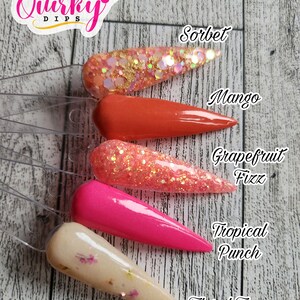 May include: Six different nail dip powder colors displayed on clear plastic sticks. The colors are: Sorbet, Mango, Grapefruit Fizz, Tropical Punch, and Floral Tea.