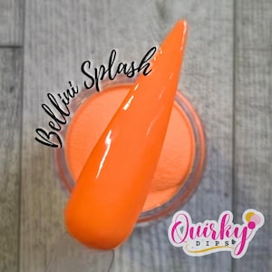 May include: A round clear plastic jar filled with vibrant orange nail dip powder. A matching orange nail swatch stick is positioned diagonally across the top of the jar. The text Bellini Splash is printed in black script above the jar.