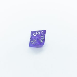 May include: A purple, iridescent, six-sided die with white numbers. The die is showing the number 40.