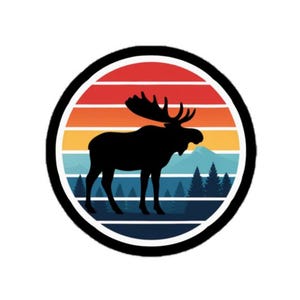 May include: A circular graphic featuring a black silhouette of a moose with large antlers, set against a sunset gradient of red, orange, yellow, and blue. The moose stands in front of a forest scene, all within a black-bordered circle.