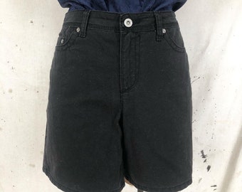 May include: Black denim shorts with a high waist and a button closure. The shorts have a relaxed fit and are made of a soft, comfortable fabric.