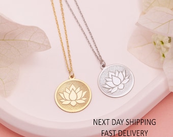 May include: Two delicate necklaces with a circular pendant featuring a lotus flower design. One necklace is gold and the other is silver.