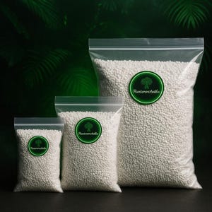 May include: Three clear plastic bags filled with white granules, sealed with a zip closure. The bags are different sizes, each bearing a green and white circular sticker with a tree graphic and the text "Plantarancholia". The backdrop is a dark green.