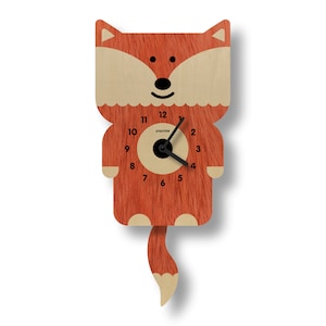 May include: A wooden fox-shaped wall clock with a red-orange fur-like texture. The clock has a light beige face with black hands and numbers. The clock's tail is also light beige. The brand name "popclox" is printed on the clock face.