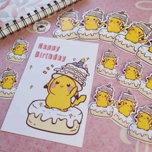 May include: A birthday card with the words "Happy Birthday" printed on it. The card features a cartoon Pikachu wearing a multi-layered cake on its head. The Pikachu is standing on a cake with white frosting and a yellow base. The card is surrounded by several stickers of Pikachu wearing cakes.