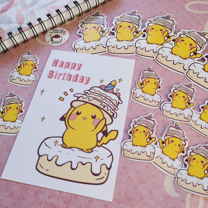 May include: A birthday card with the words "Happy Birthday" printed on it. The card features a cartoon Pikachu wearing a multi-layered cake on its head. The Pikachu is standing on a cake with white frosting and a yellow base. The card is surrounded by several stickers of Pikachu wearing cakes.
