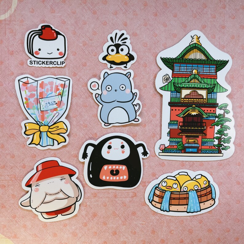 May include: A set of ten colorful stickers featuring various characters and designs. The stickers include a red and white sushi roll, a blue and white Totoro character, a green and red Japanese temple, a black and white No Face character, a yellow and white chick, a pink and white flower bouquet, and a red and white character with a hat.