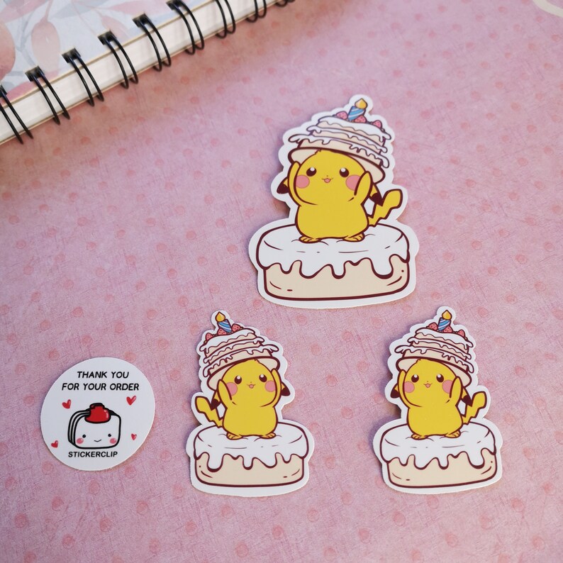 May include: Three stickers featuring a cartoon Pikachu wearing a birthday cake hat. The Pikachu is standing on a cake with white frosting. The stickers are on a pink background with white polka dots. The text "Thank you for your order" and "Stickerclip" is on a separate sticker.