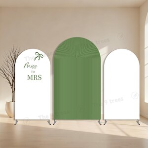 May include: Three-panel wedding backdrop. The center panel is olive green with a ribbed texture. The left panel is white with the text "Miss to MRS" in green. The right panel is white. All panels have a curved top.