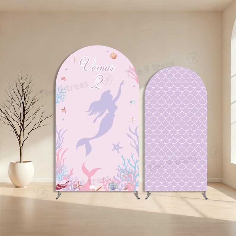 May include: Two arched backdrop covers featuring a light pink theme. The left cover displays a purple mermaid silhouette, the text Vernus 2, and various sea life illustrations. The right cover features a repeating purple mermaid scale pattern.