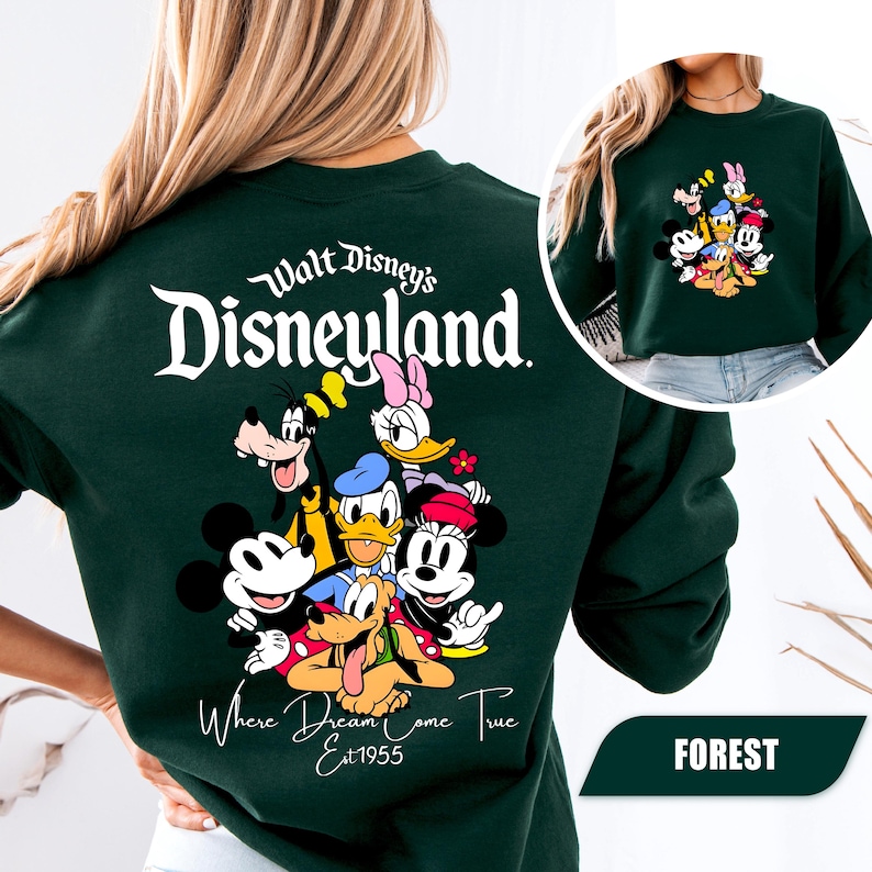 May include: A dark green crewneck sweatshirt featuring a large graphic on the back with the text Walt Disney's Disneyland Where Dreams Come True Est 1955 and illustrations of Mickey Mouse, Minnie Mouse, Donald Duck, Daisy Duck, Goofy, and Pluto.