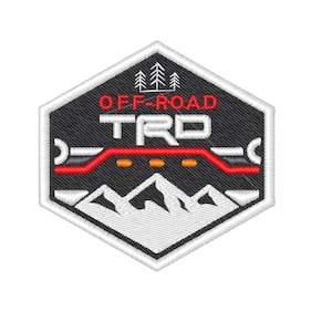 Op de afbeelding: Zwarte en witte geborduurde patch met een rood en wit vrachtwagen silhouet, bergen en de tekst "OFF-ROAD TRD".