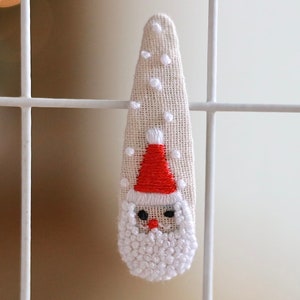 White Santa Claus Hair Clips. Santa hair barrettes. Santa Snap Hair Clips. Santa Snap Clip with Snow Flakes. White Santa Hair Clip with Red Hat. Red hat Santa hair clip.