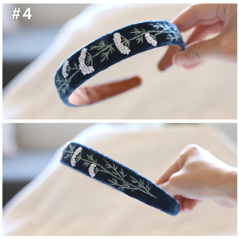 May include: A dark blue velvet headband with white bead and green embroidery of a floral design.