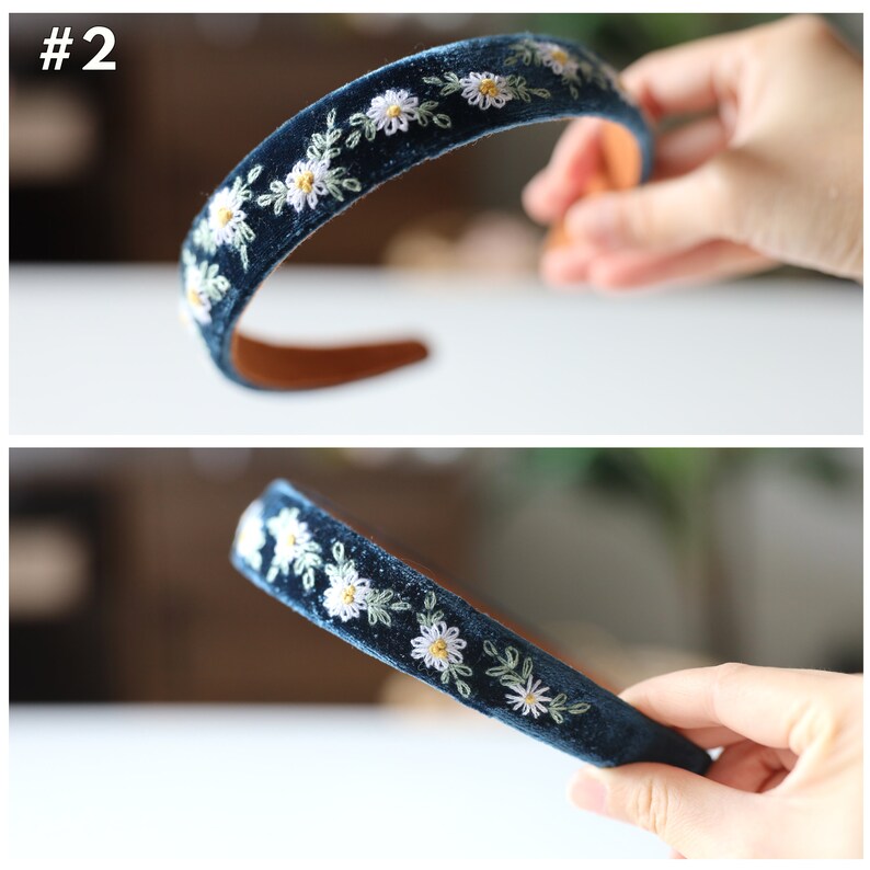 May include: A dark blue velvet headband with white daisy embroidery. The headband is shown from two angles.