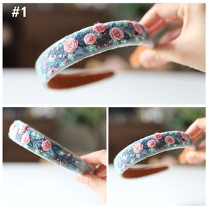 May include: A light blue headband with pink and green embroidered flowers.